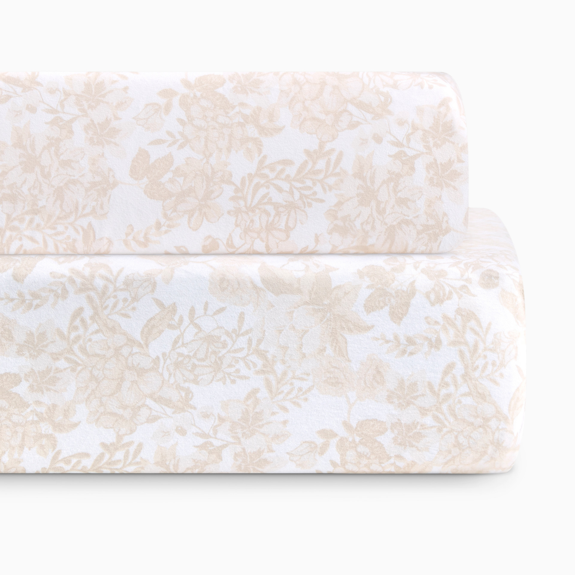 Close-up of floral patterned fabric in beige and white.