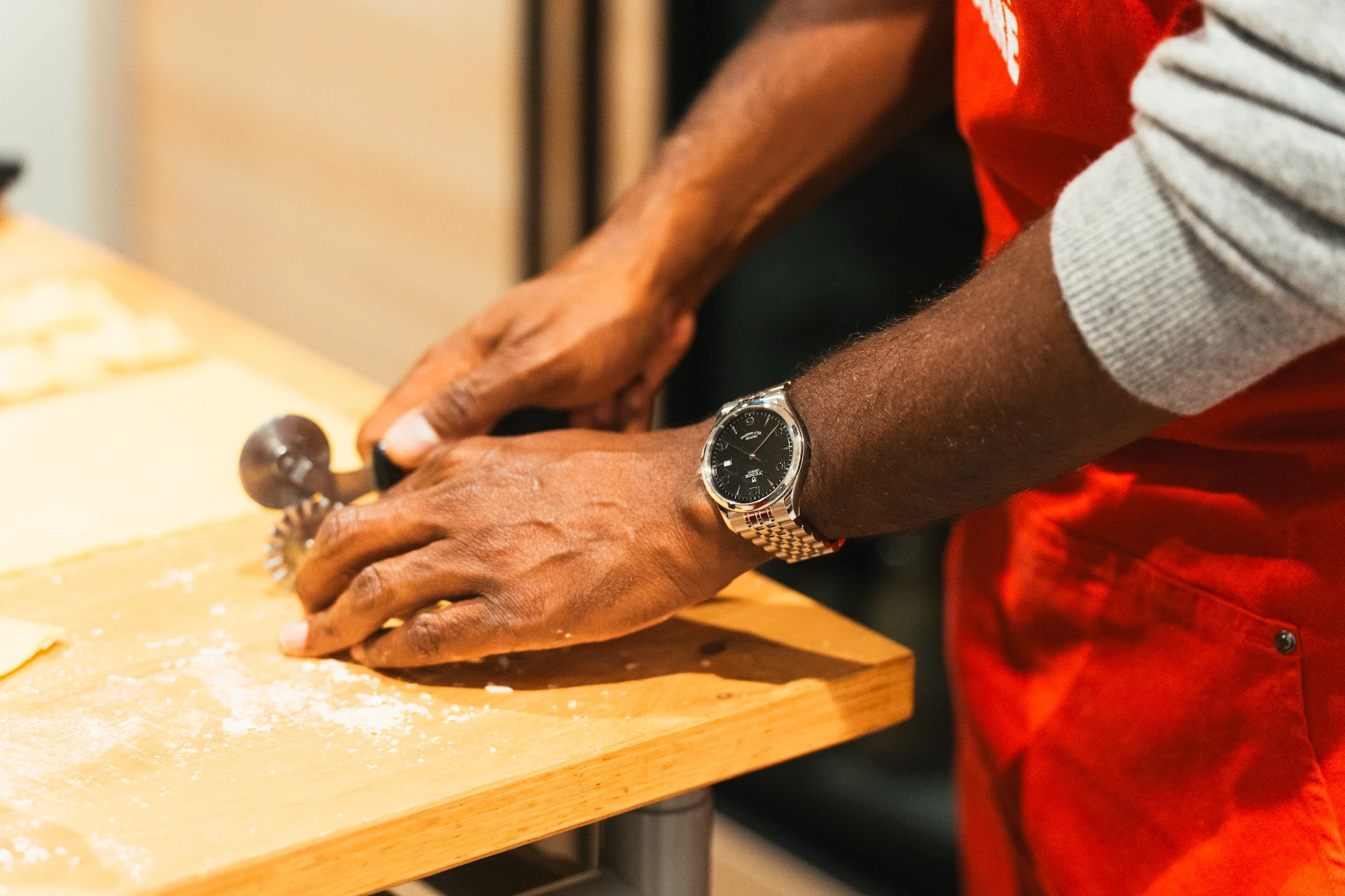 TUDOR at Eataly making pasta on a table with a TUDOR watch at their wrist