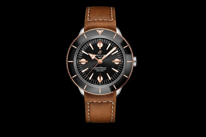 two tone superocean heritage 57 with a black dial and gold brown vintage inspired leather strap 