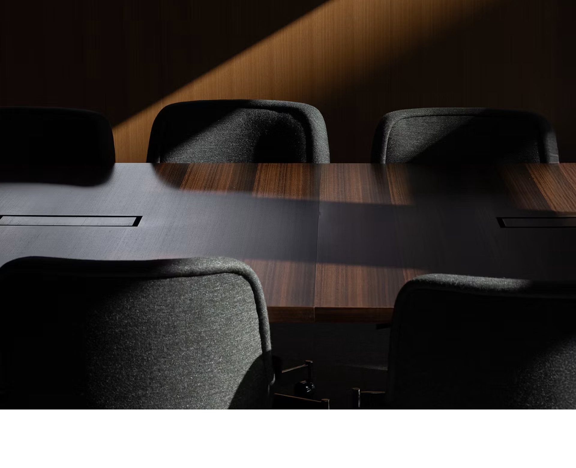 Bumper Conference Chairs with low arms upholstered with Bellano Black Green around a JD Conference Table in Fumed Quarter Cut Eucalyptus.