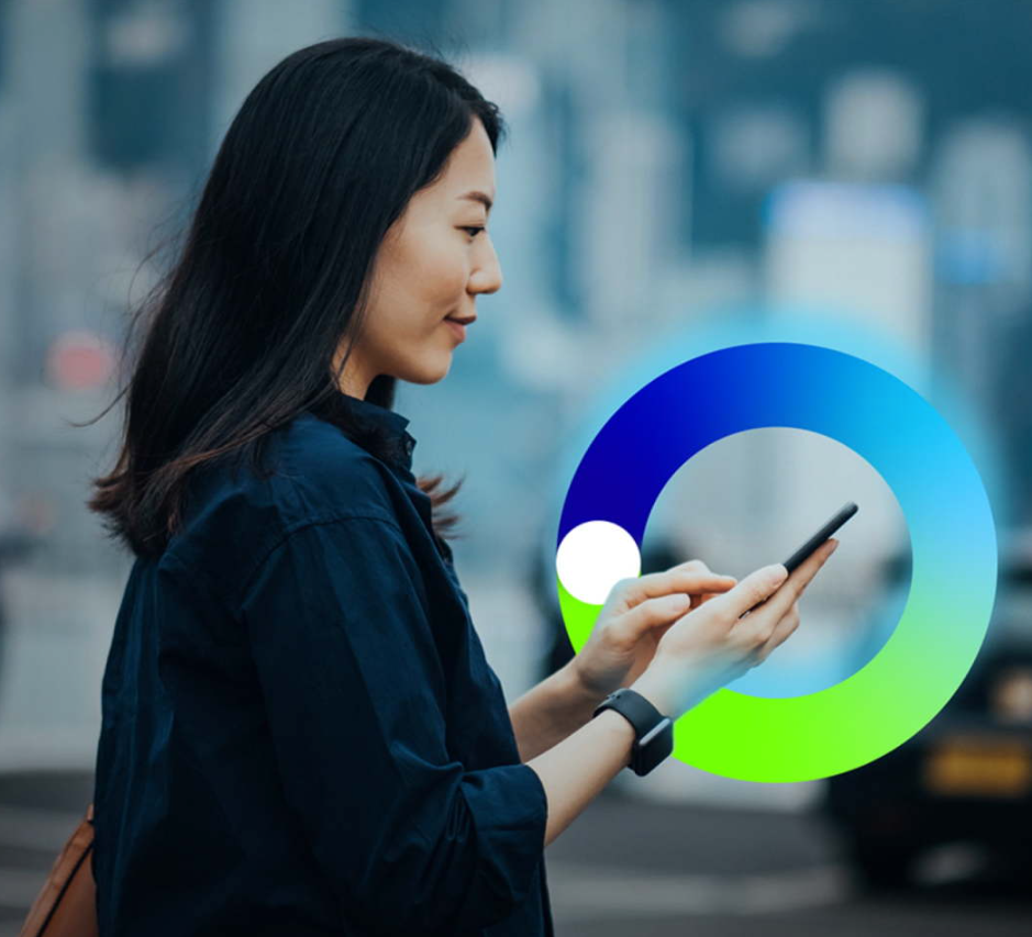 A photo of a young woman looking at her photo in a city. There is a bp pulse EOM around her phone.