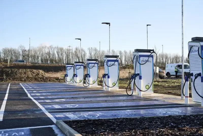 A photo of the bp pulse Cransley Park EV hub in Kettering. You can see several chargers and parking bays.