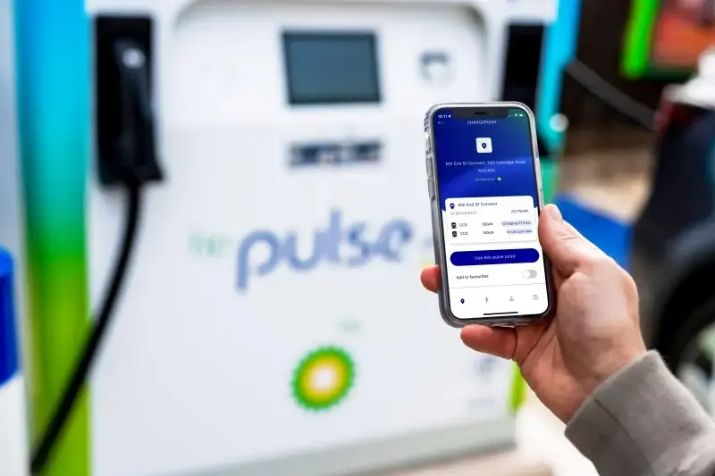 A photo showing a close up of the bp pulse app on a man's phone. In the background you can see an ultra-fast bp pulse charger.