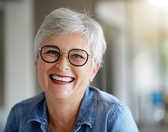Lächelnde Frau mittleren Alters mit Brille