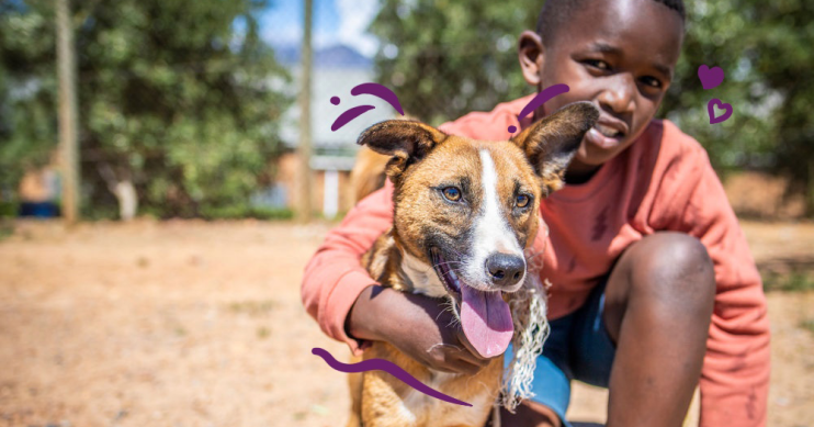 Picture of child holding dog.