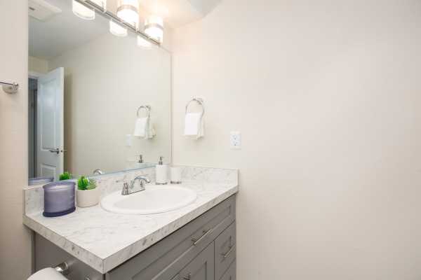 Photo of modern bathroom sink and cabinets at Casa Blanca apartments.