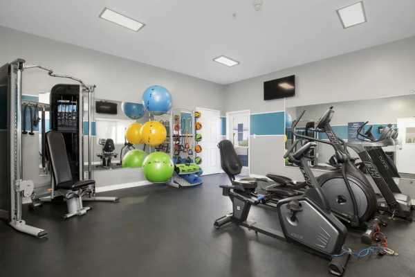 Community workout room with exercise bikes and other equipment