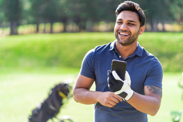 Man on golf course with phone