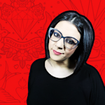 A headshot of Salma wearing black on a red patterned background.