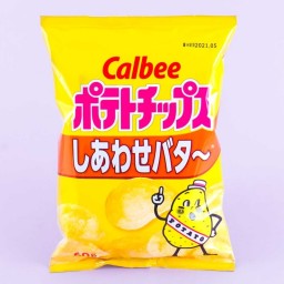 A yellow bag of potato chips in the "happy butter" flavor. There is an illustration of a potato with its finger pointing skywards on the bag.