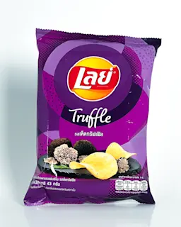 A purple bag of Lay’s chips where most of the writing is in Thai. In English it says truffle. There is an illustration of truffle mushrooms and potato chips.