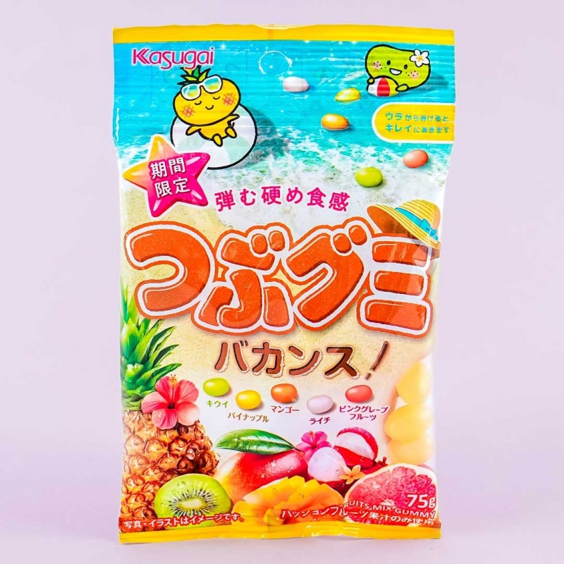 A bag of jelly beans in various tropical flavors: kiwi, pineapple, mango, lychee, and pink grapefruit.