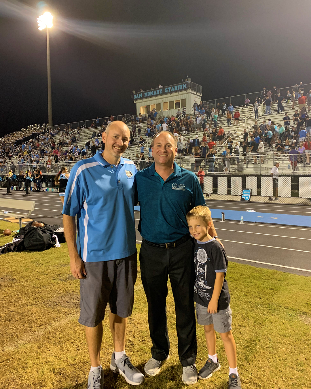 Dr. Michael D. McCleary of the Orlando Orthopaedic Center with the center's foundation lead Andy Reber and his son.