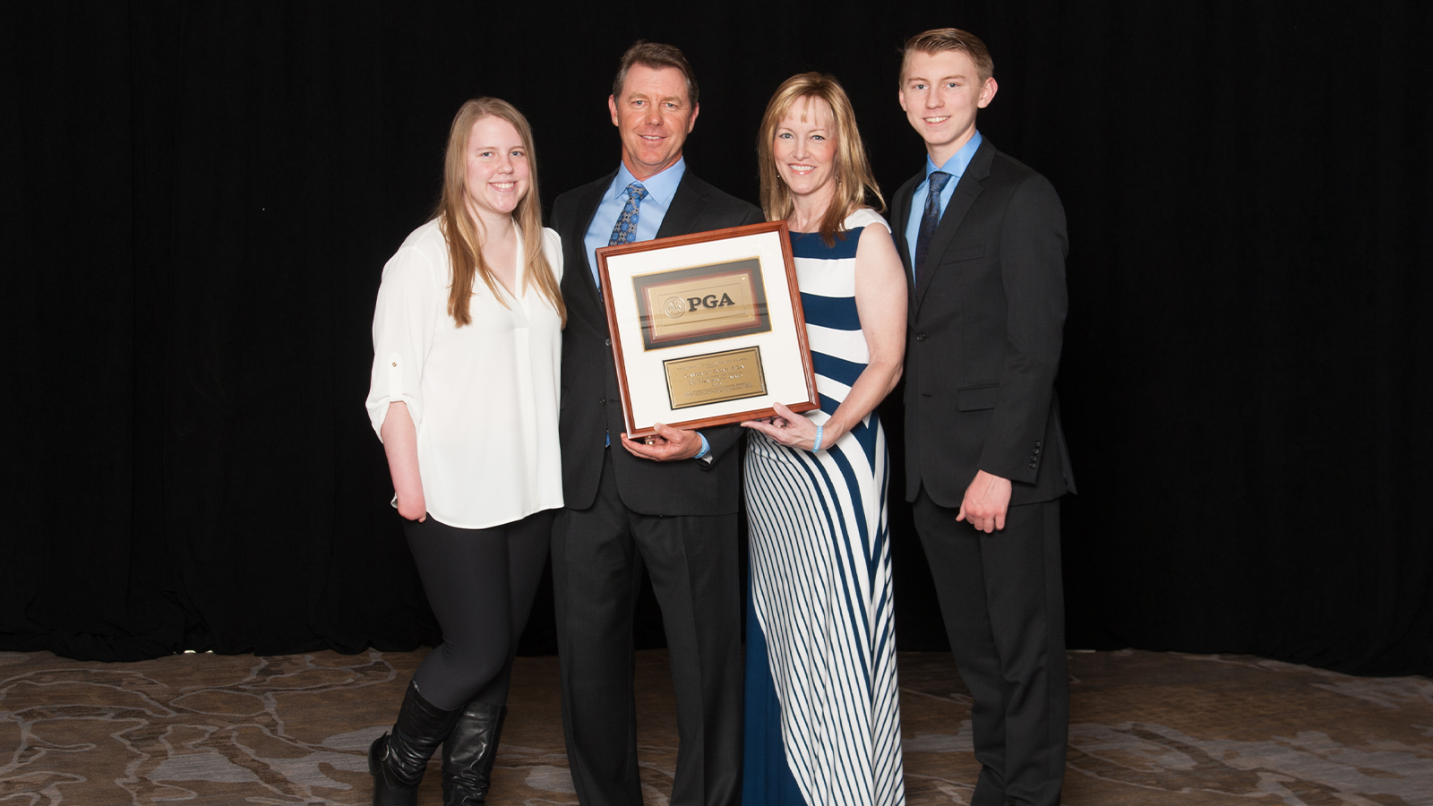 Cameron Doan, Bill Strausbaugh Award winner, & his family during the 102nd Annual Meeting at the Renaissance Indian Wells Resort & Spa on November 6, 2018 in Indian Wells, California. (Photo by Darren Carroll/PGA of America)