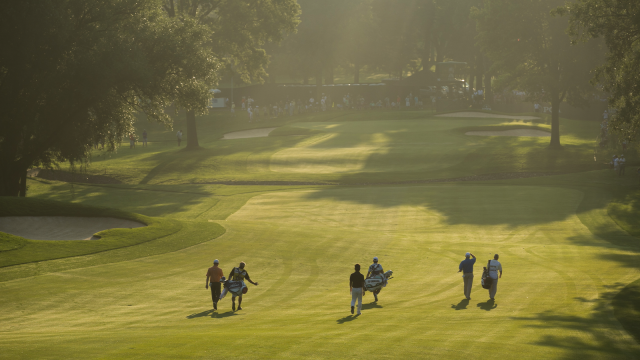A group walks the 10th fairway at the Oak Hill Country Club.