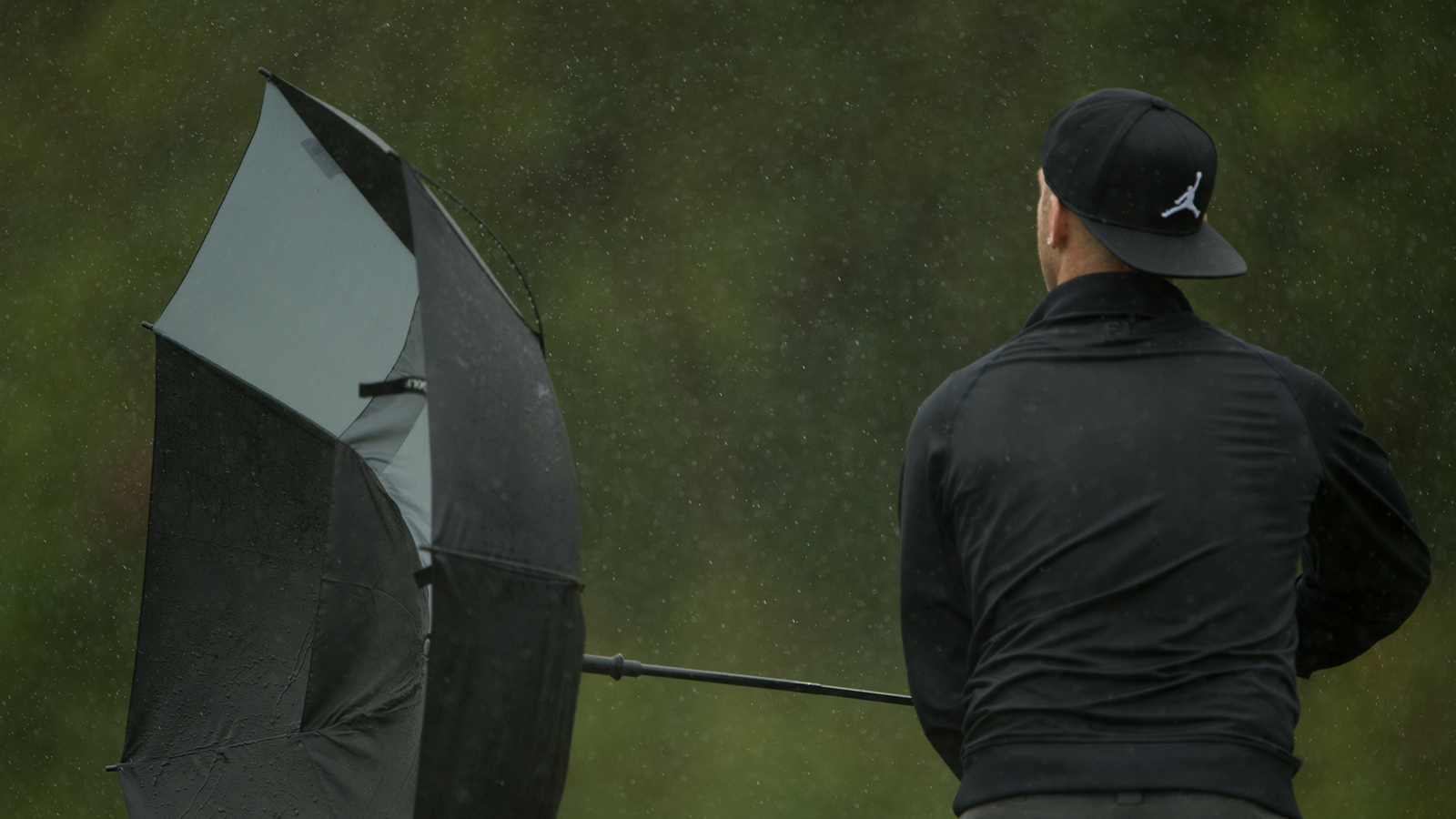 Derek Berg fixes his umbrella on the 12th green during Final Round of the 41st National Car Rental Assistant PGA Professional Championship.