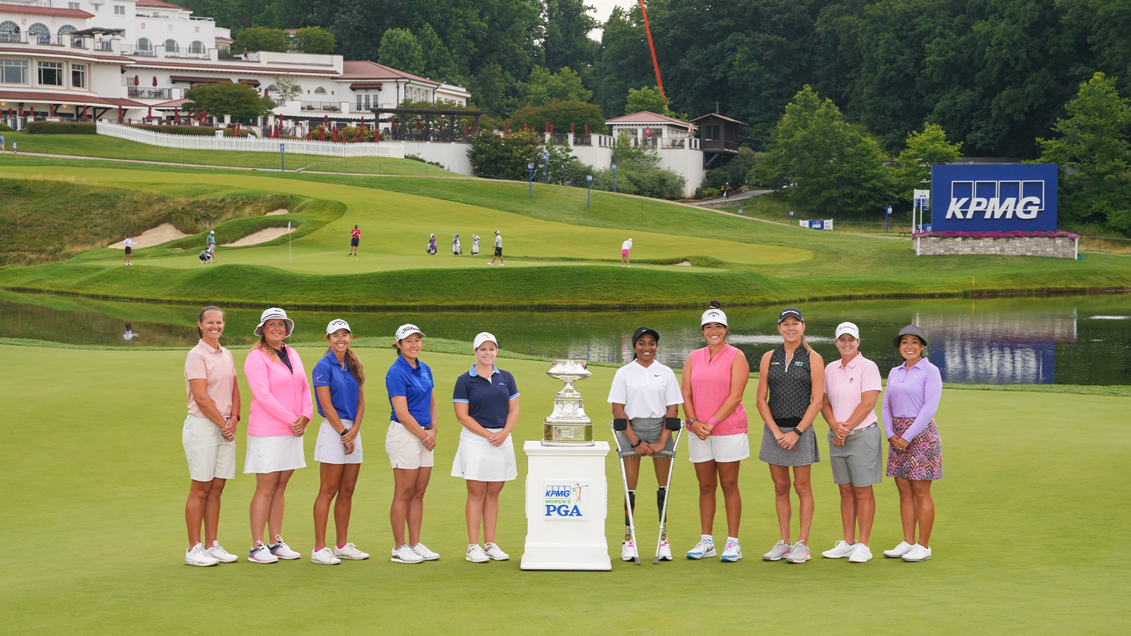  PGA and LPGA Professionals gather for a photo around the KPMG trophy and Taz Wilson during a practice round for the 2022 KPMG Women's PGA Championship at Congressional Country Club on June 22, 2022 in Bethesda, Maryland. (Photo by Darren Carroll/PGA of America)