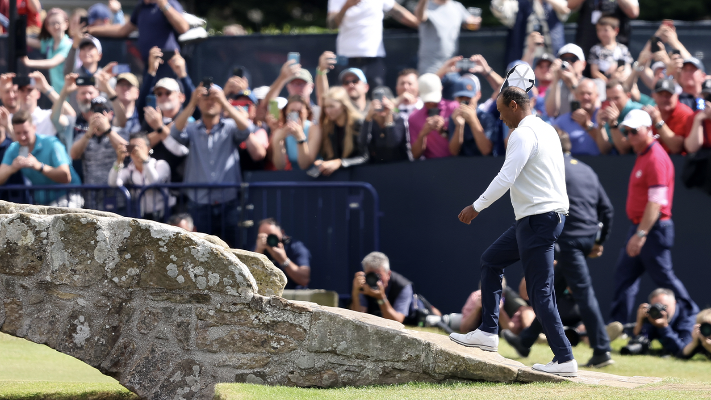 Tiger Woods waves to the crowd as he crosses the Swilcan Bridge during Day Two of The 150th Open at St Andrews Old Course on July 15, 2022 in St Andrews, Scotland.