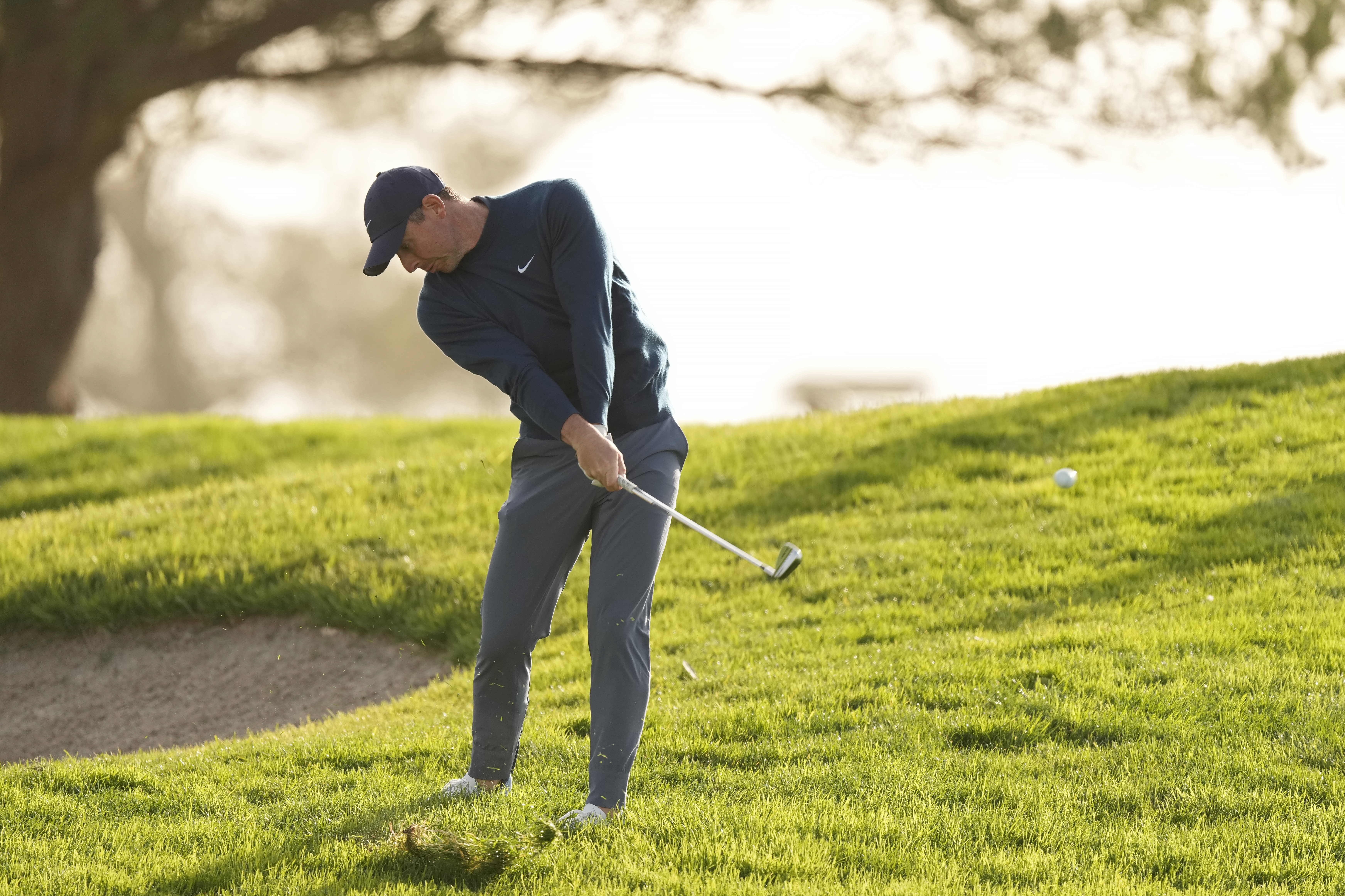 Rory McIroy battling the heavy rough at Torrey Pines.