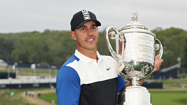 Brooks Koepka holds the Wanamaker Trophy after his win at Bethpage Black in 2019.