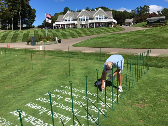 McKinley painting names on the Tee of Triumph, which honored Michigan's fallen soldiers. 