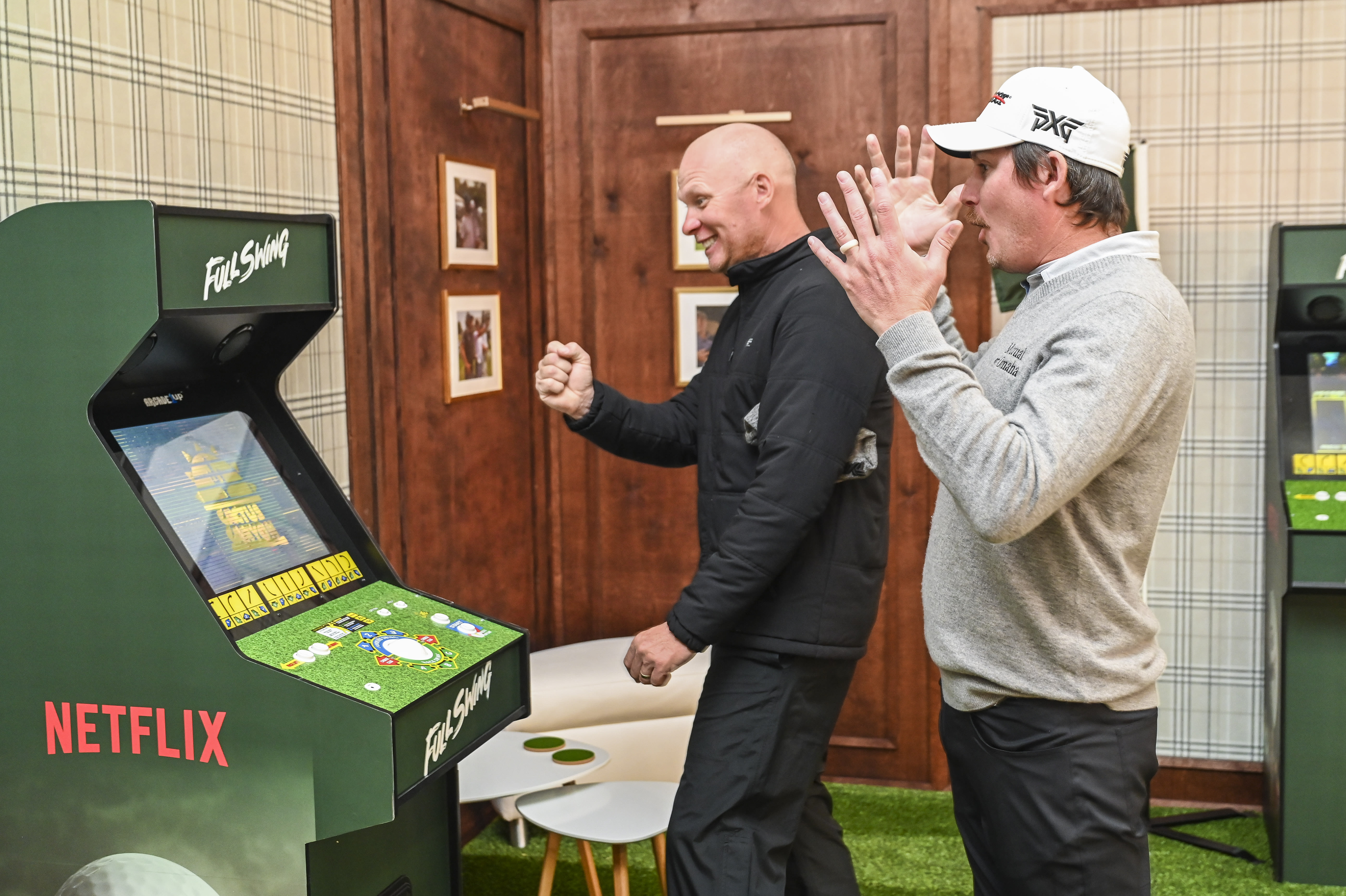 Joel Dahmen and caddie Geno Bonnalie tackle a Golden Tee session at this year's Genesis Invitational. (Keyur Khamar/PGA TOUR via Getty Images) 