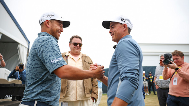 Xander Schauffele and Rickie Fowler shake hands after setting the new U.S. Open single round scoring record. (Photo: James Gilbert / USGA)