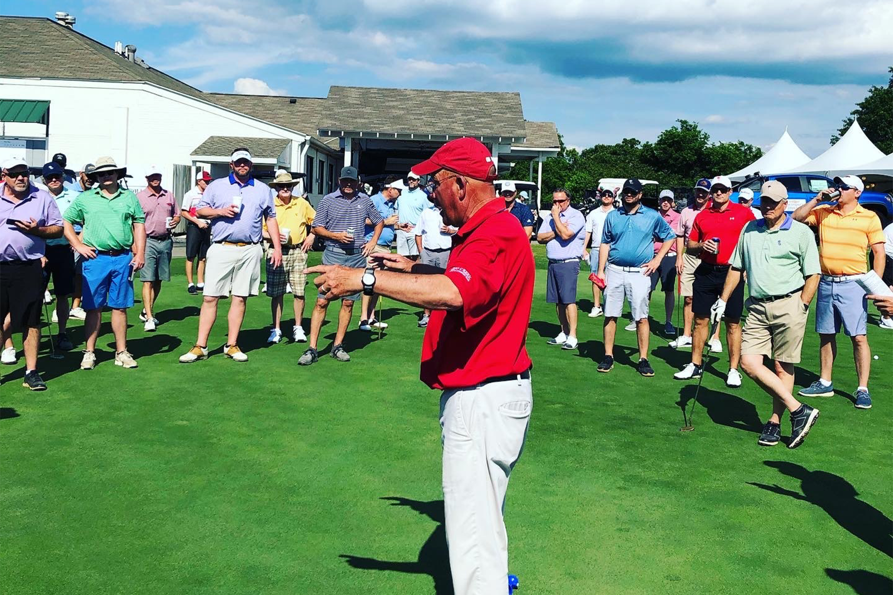 Bill Agler, PGA, working the crowd at the start of an event. 