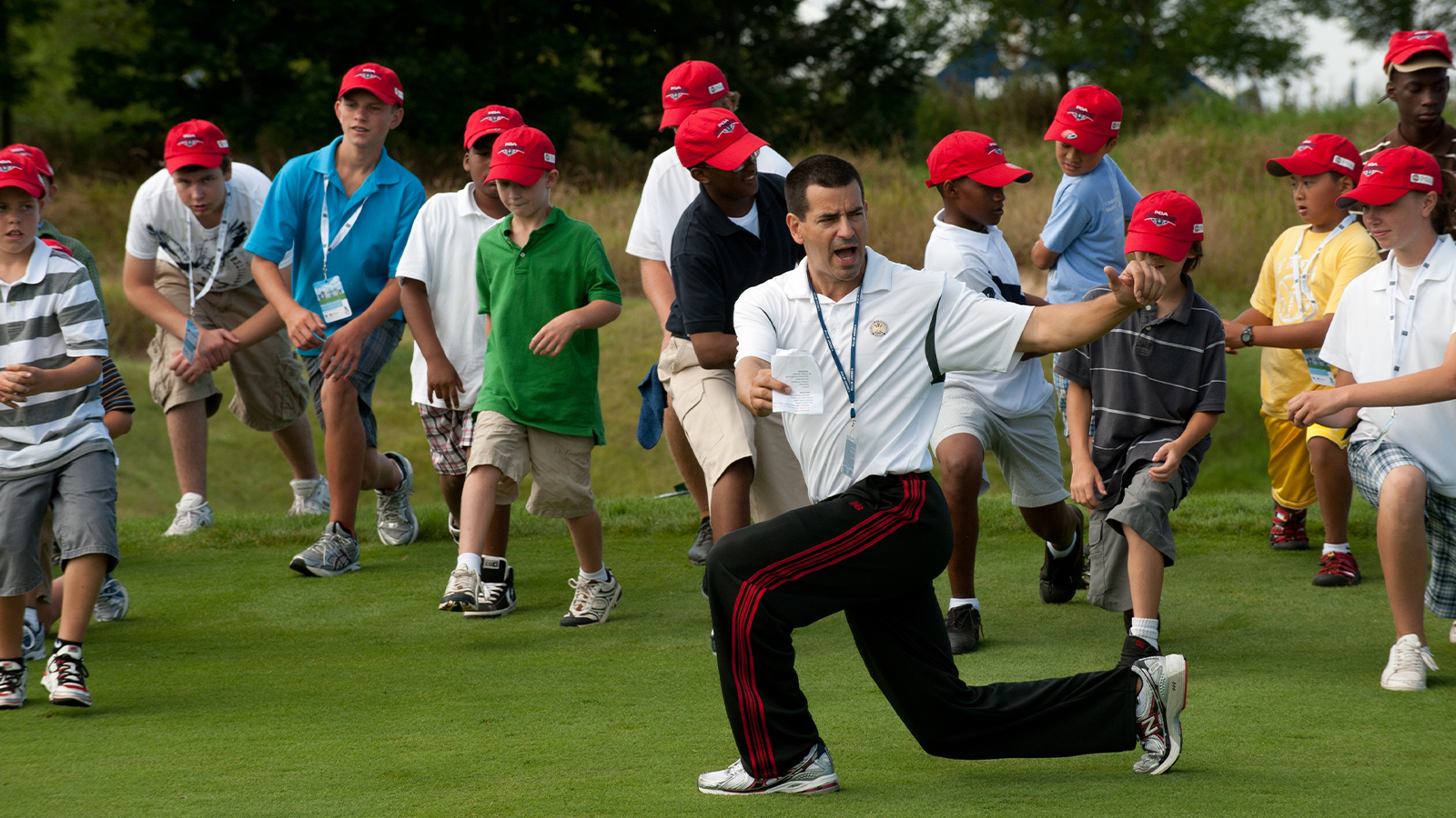David Donatucci working with Juniors on exercises during a youth clinic. (Photo by Montana Pritchard/The PGA of America)