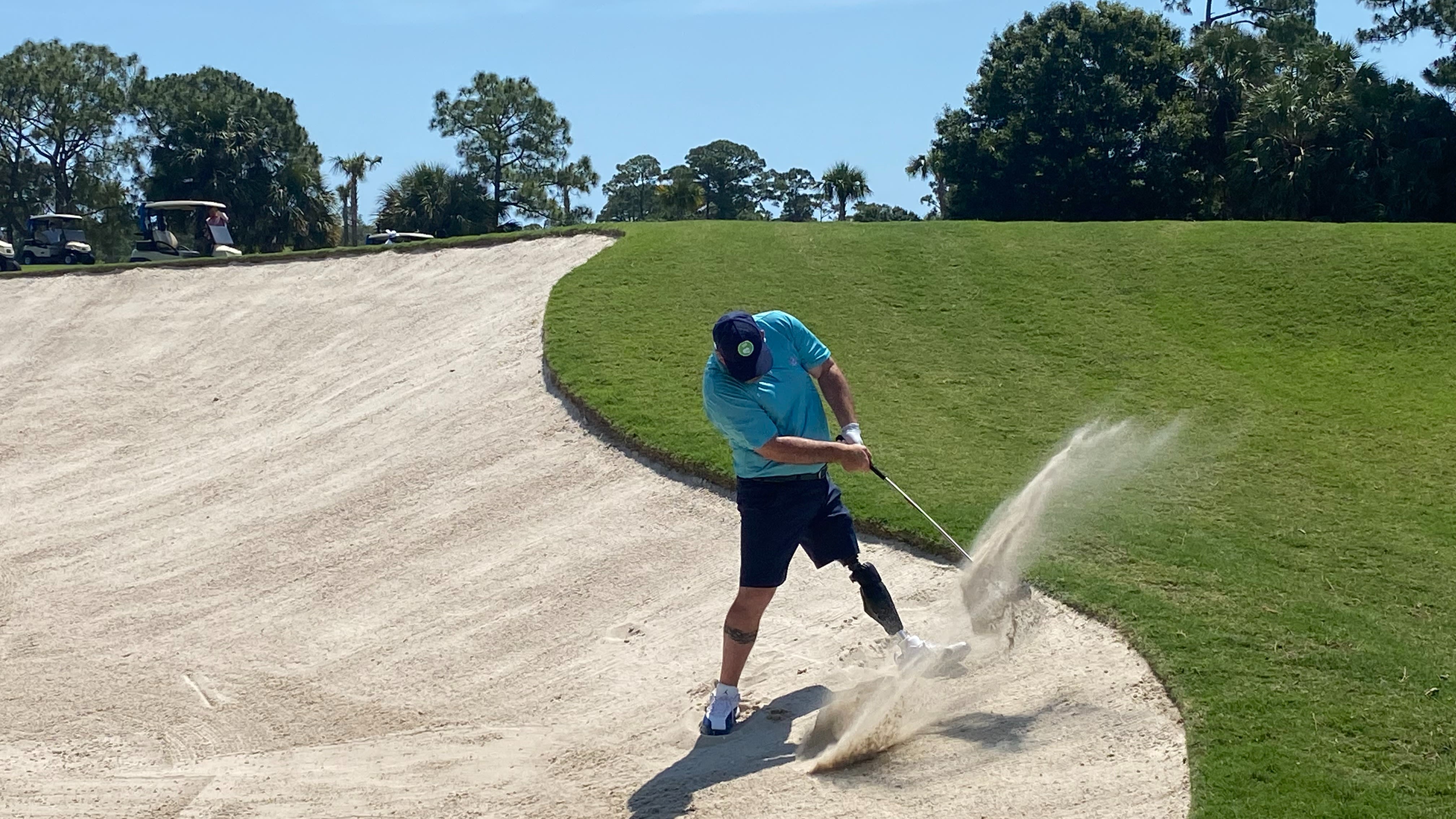Chad Pfeifer splashes out of a bunker during Round 2 at PGA Golf Club.