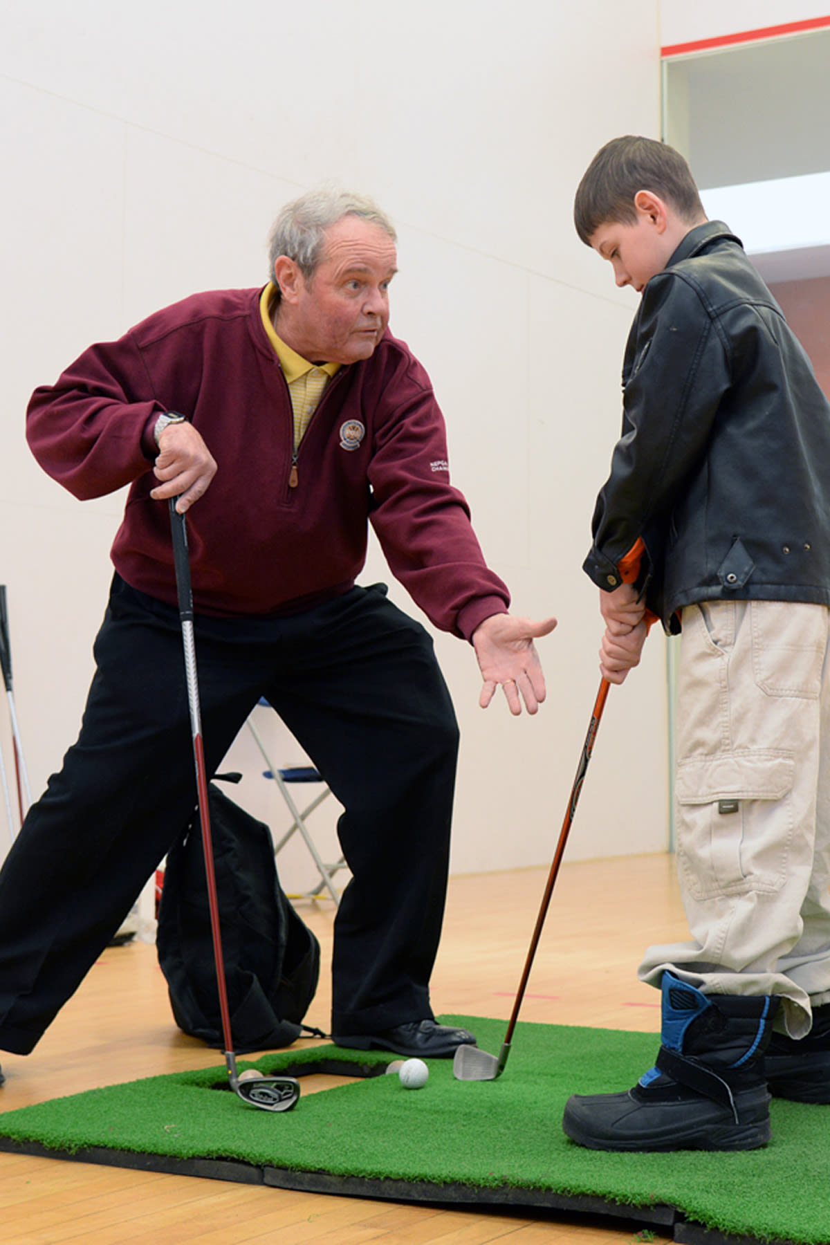 Jim Tobin, PGA, works with Joshua St. Pierre on his swing. (U.S. Air Force photo by Linda LaBonte Britt)