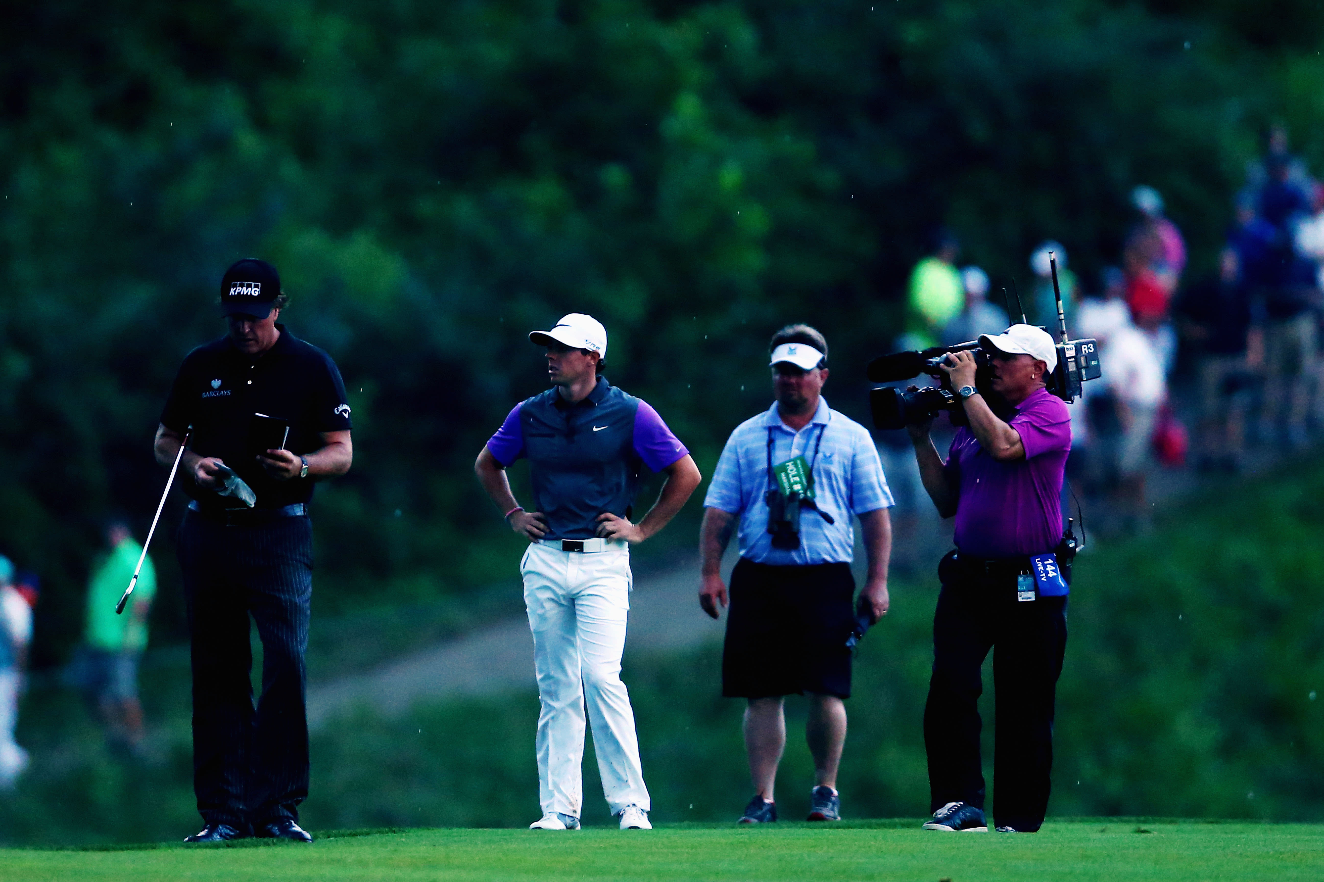 Mickelson and McIlroy on the 18th fairway.