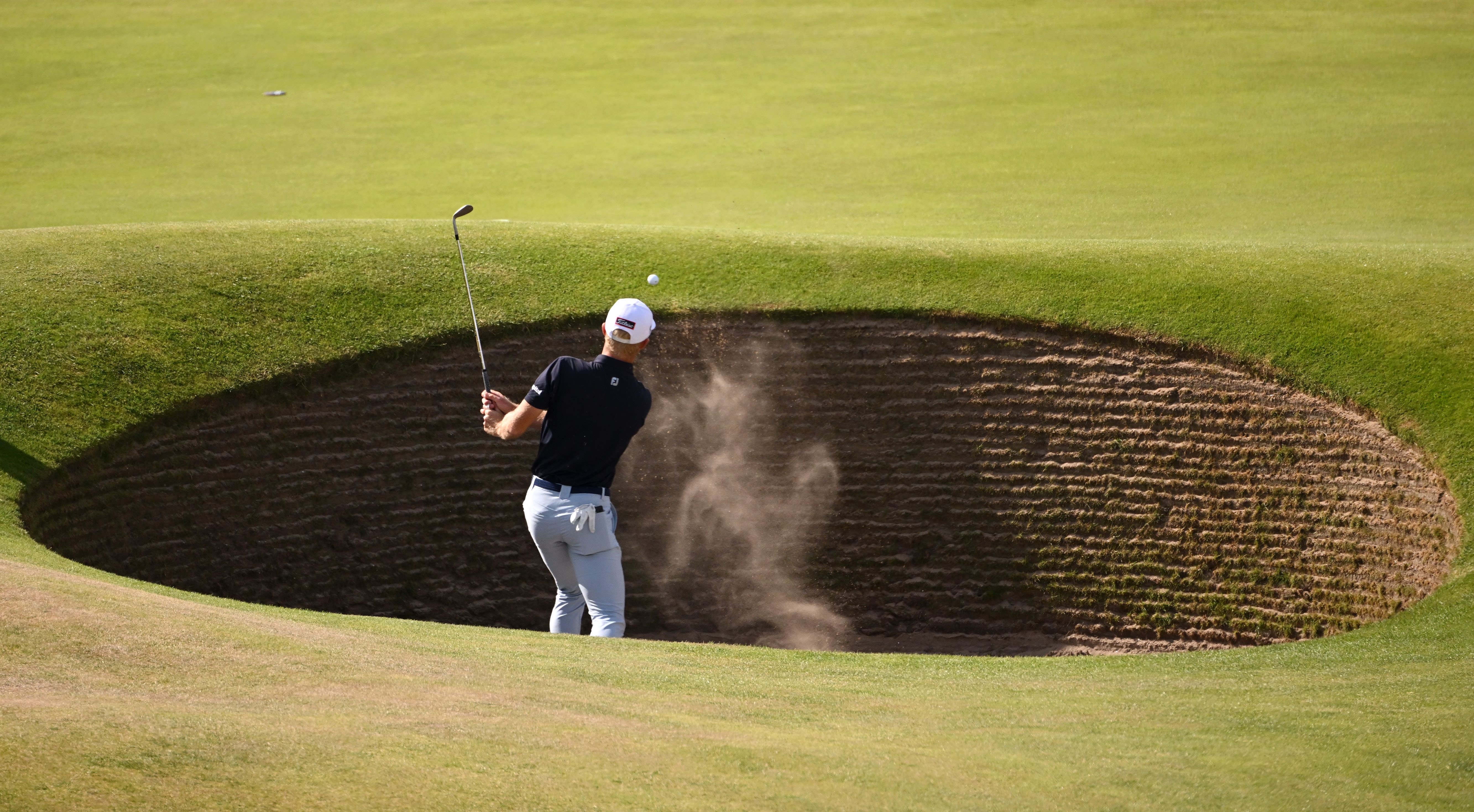 Will Zalatoris plays a shot from the bunker during a practice round prior to The 150th Open at St Andrews Old Course.