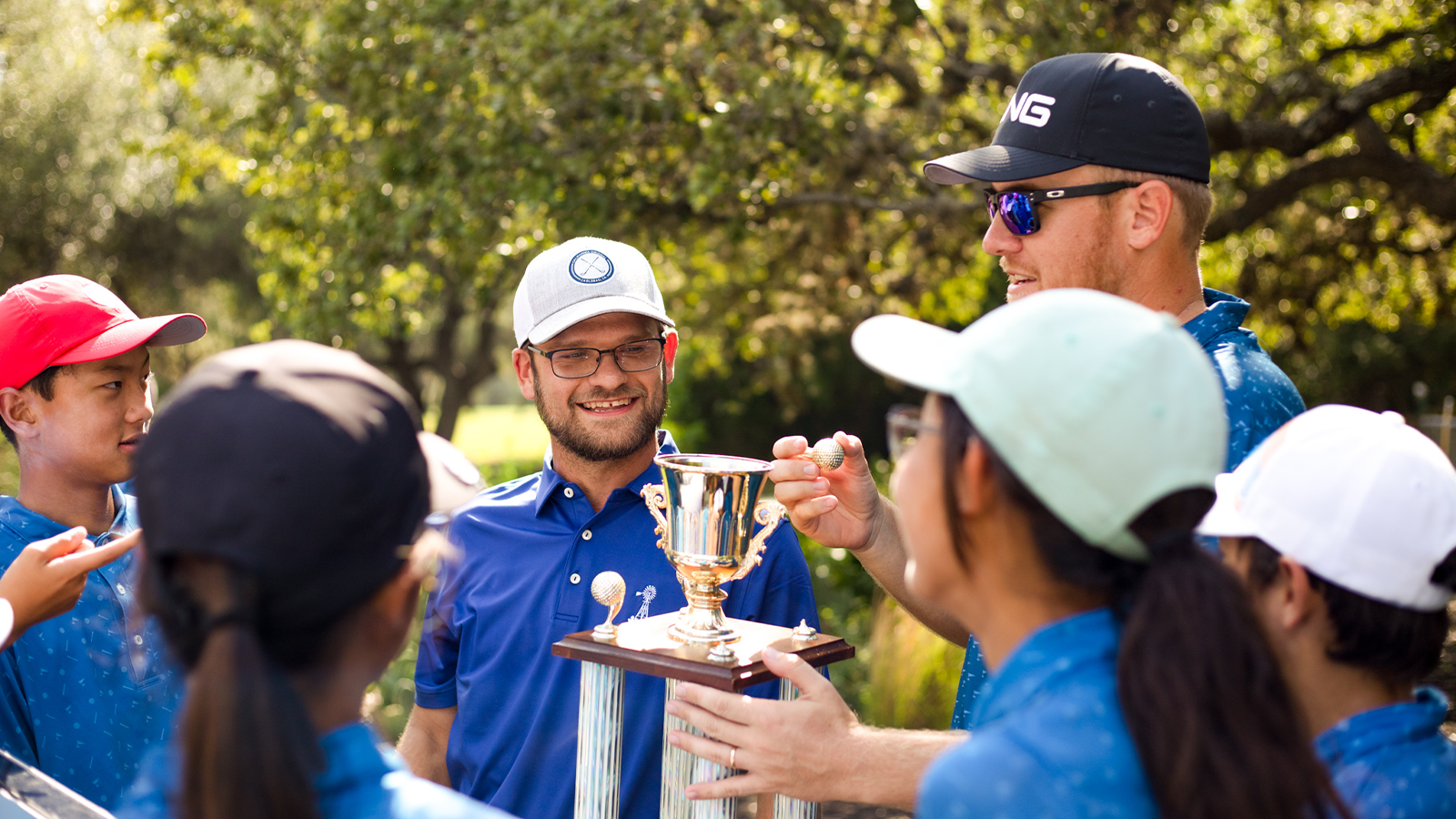 Coach celebrates with his team after the victory at the PGA Jr. League Southern Texas Section Championship. 