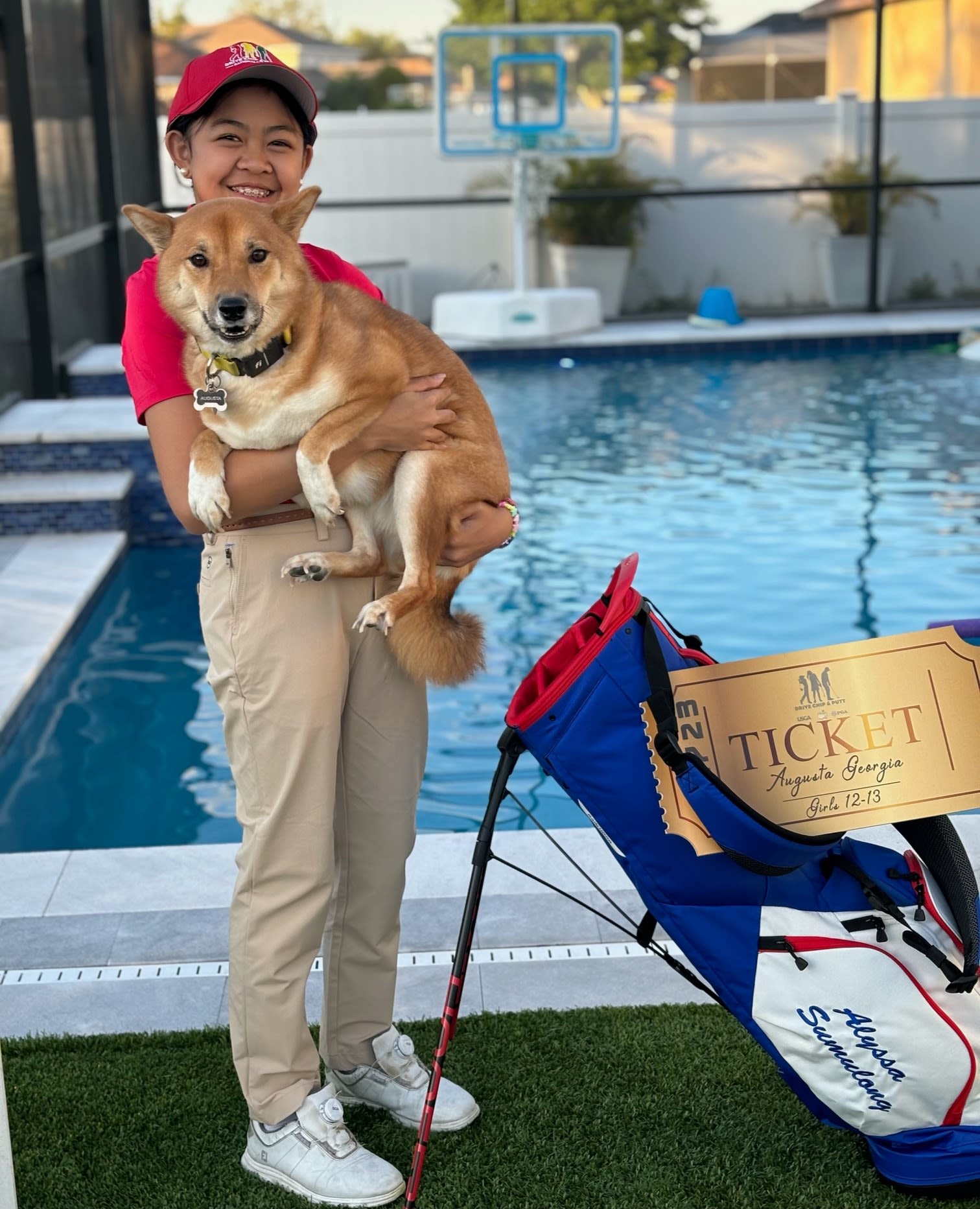 Alyssa with her dog and National Finals ticket prior to traveling to Augusta.