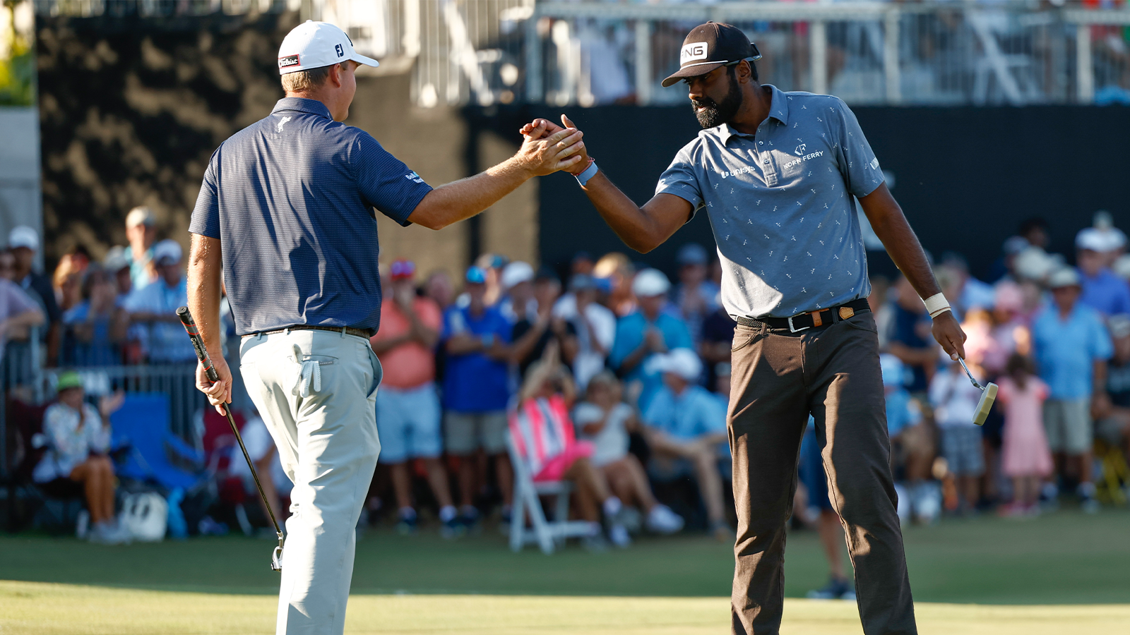 Sahith Theegala celebrates with Tom Hoge of the United States after putting the winning birdie on the eighteenth green during the final round of the QBE Shootout at Tiburon Golf Club on December 11, 2022 in Naples, Florida. (Photo by Douglas P. DeFelice/Getty Images)