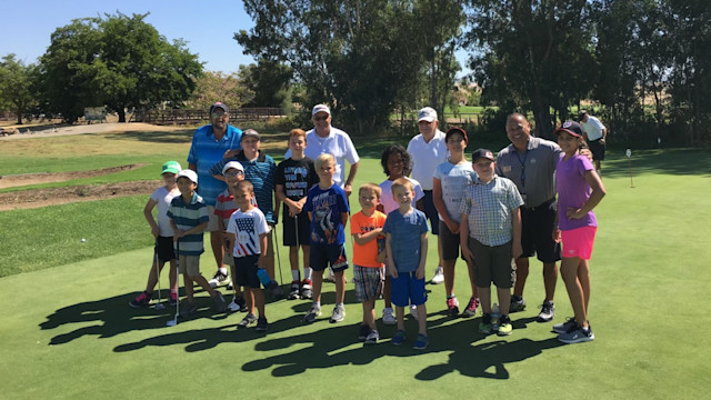 Ken Yuson (far right) shares his passion for the game with every new player he meets.