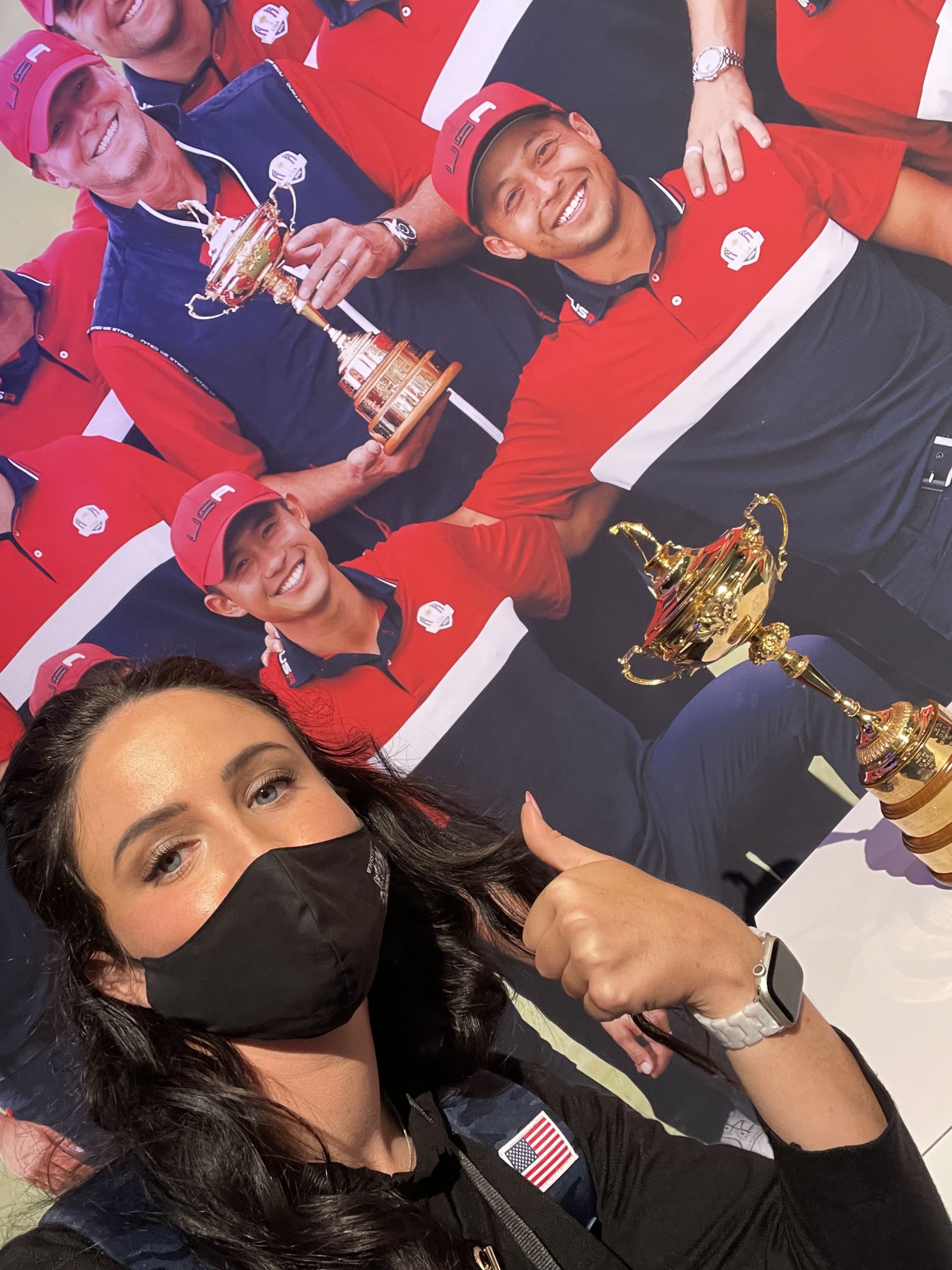 Abby Parsons reliving the U.S. Team winning the Ryder Cup with the photo at the PGA Show. 