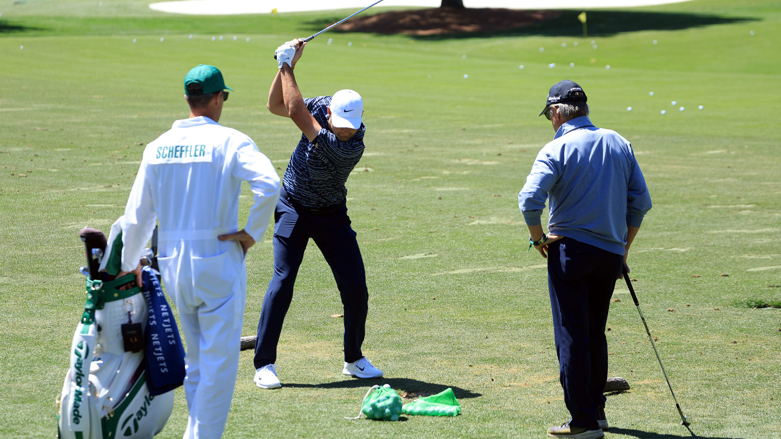 Scottie Scheffler and Randy Smith on the range before the final round of the 2022 Masters.