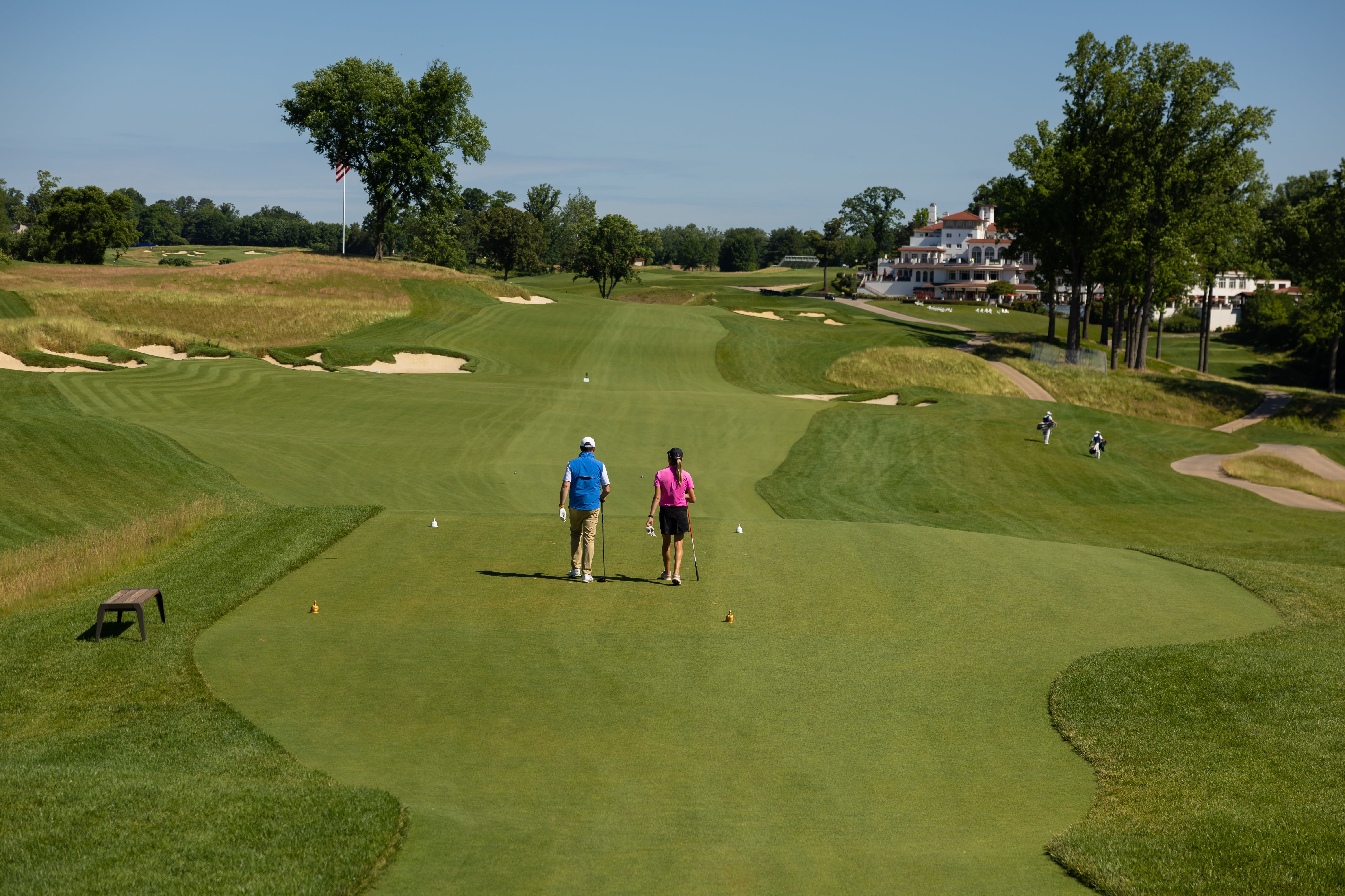Jason Epstein, PGA and PGA Professional, Ashley Grier walk on the 15th fairway at Congressional Country Club 
