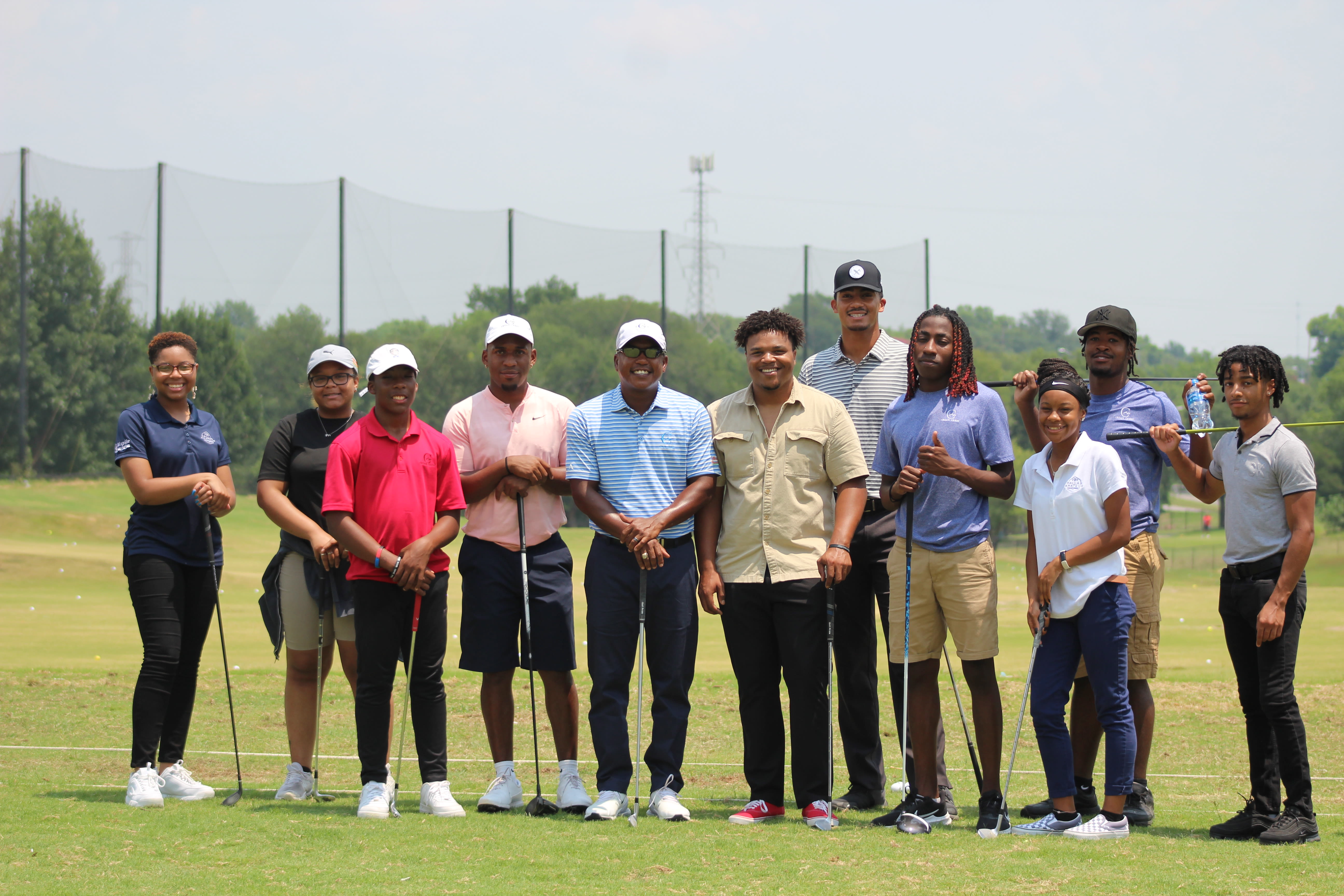 Molayo (middle) with I AM a Golfer program participants.