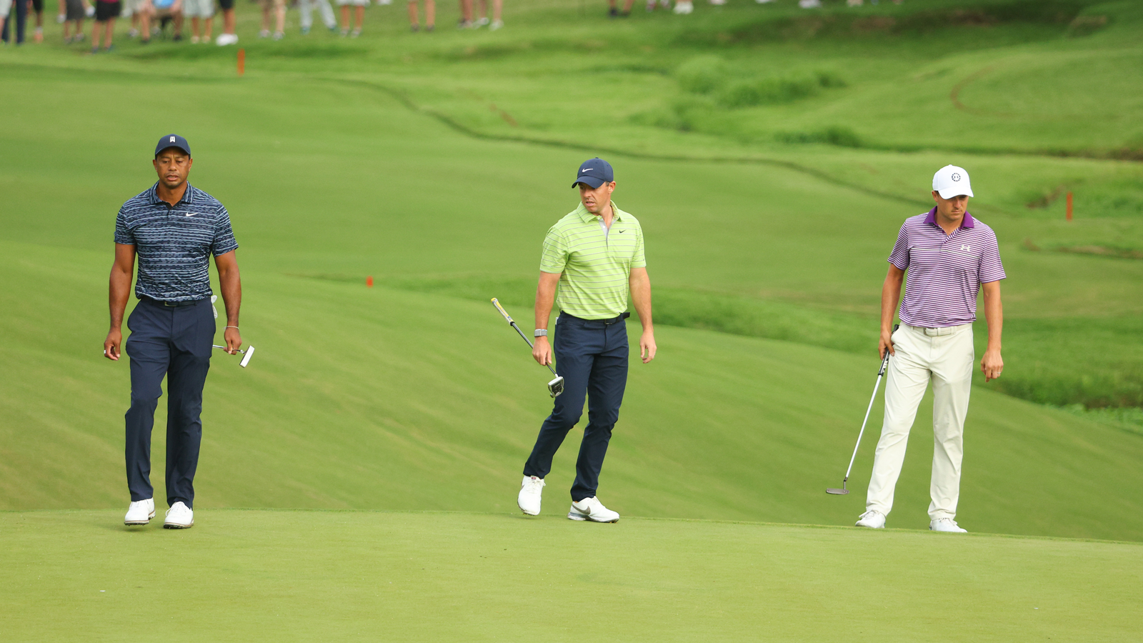 Tiger Woods, Rory McIlroy and Jordan Spieth study the 10th green during the first round of the 2022 PGA Championship.(Photo by Andrew Redington/Getty Images)