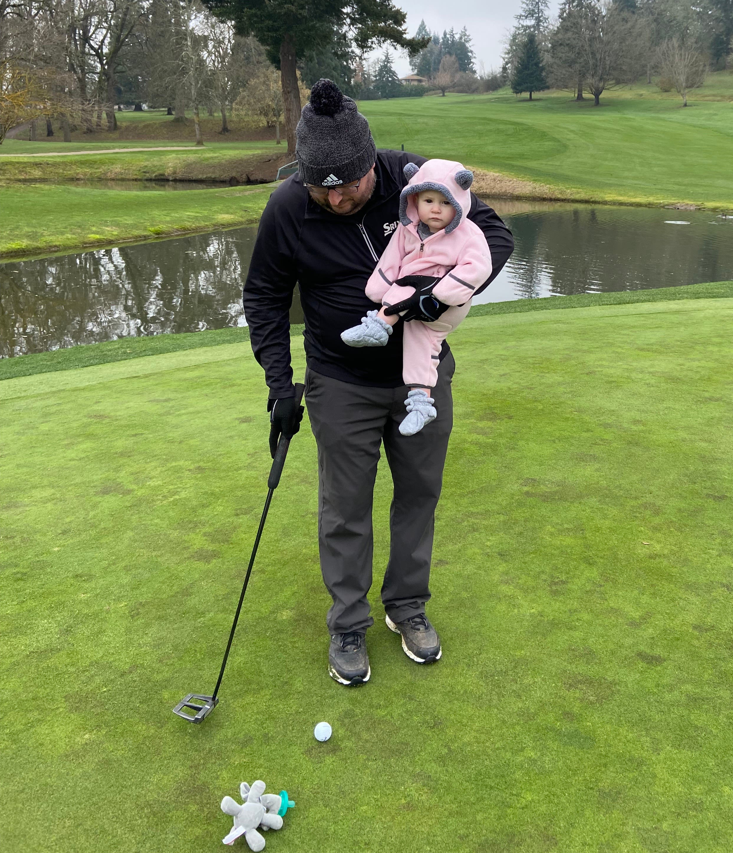 Oakley on the practice tee with daughter, Kallaway, who celebrated her first birthday last December.