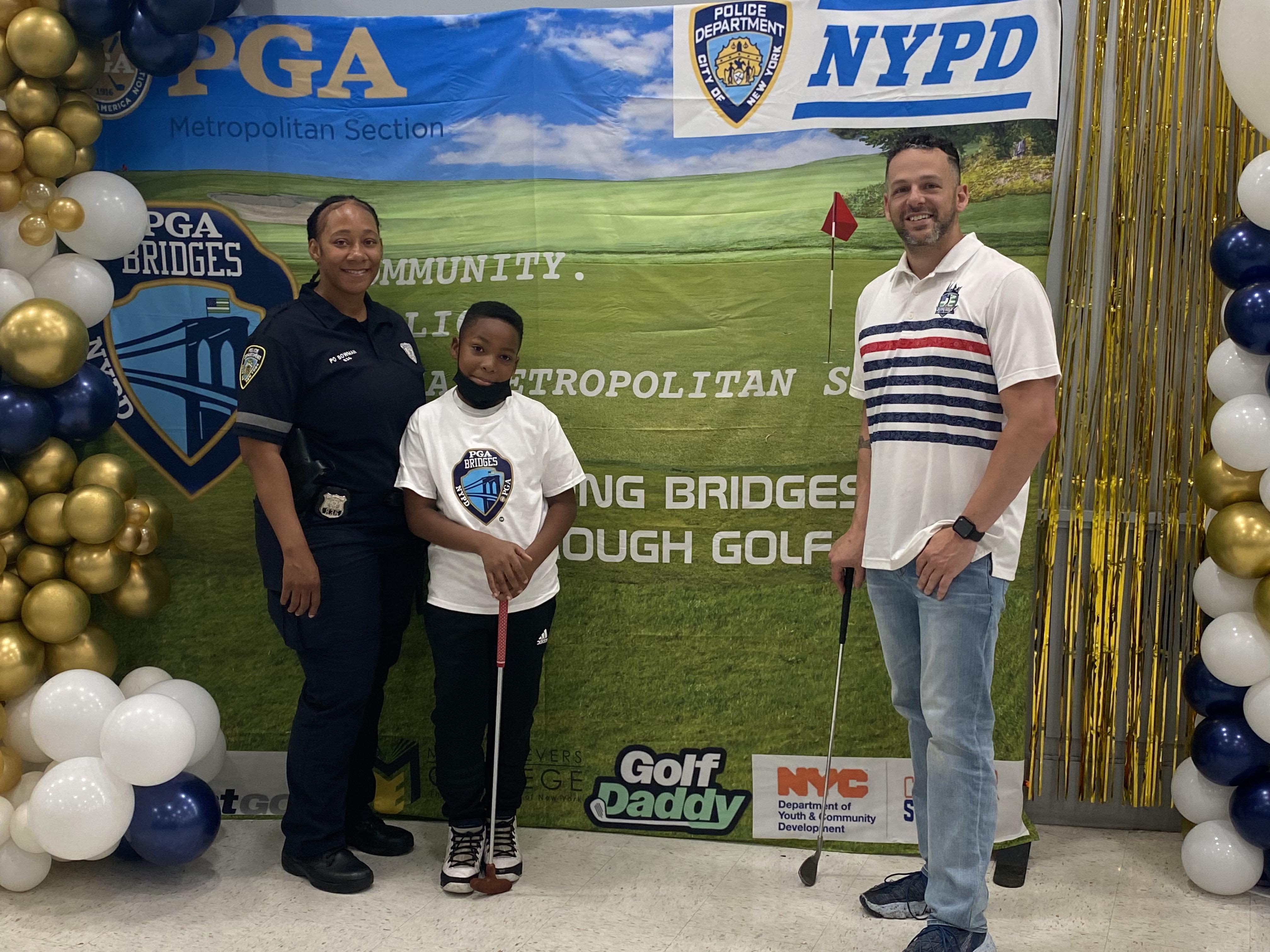 Vincenzo Rallo, PGA, at the Met PGA Bridges event with a participant and fellow NYPD member.