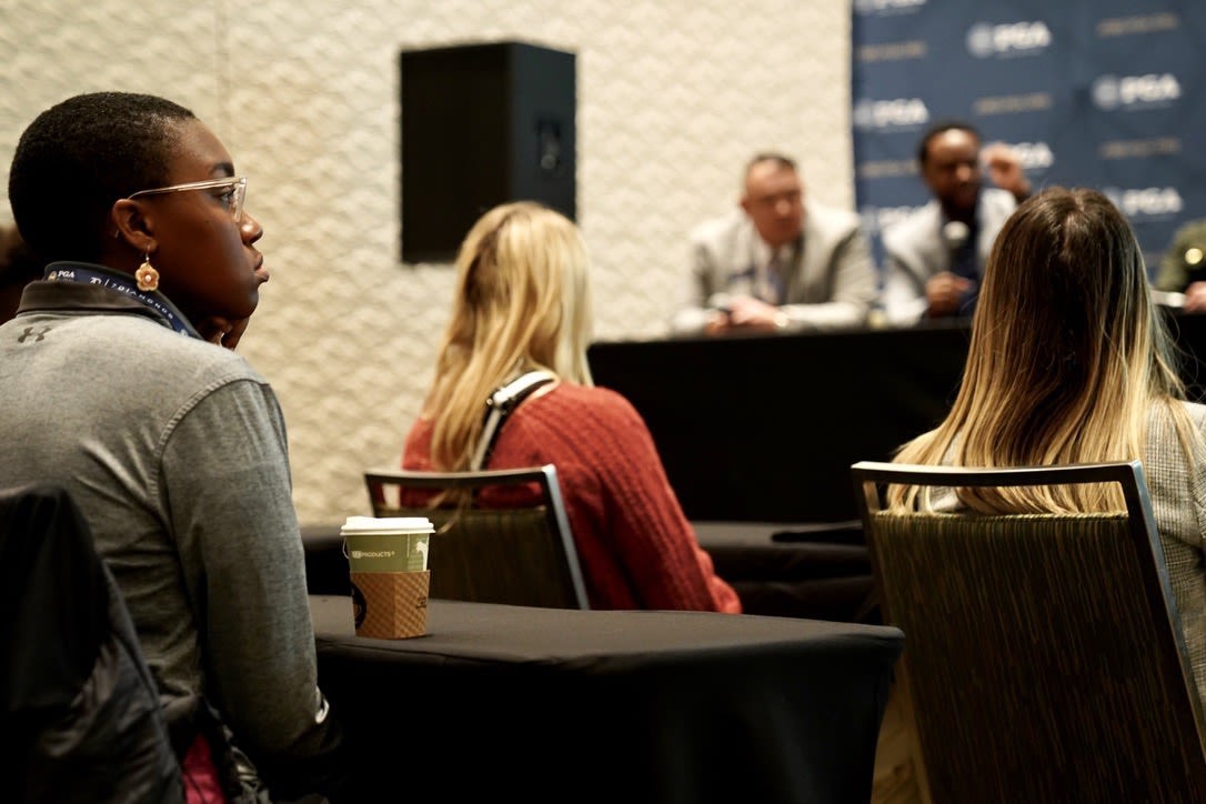 A Career Exploration Day attendee listens to a panel discussion on working in golf.