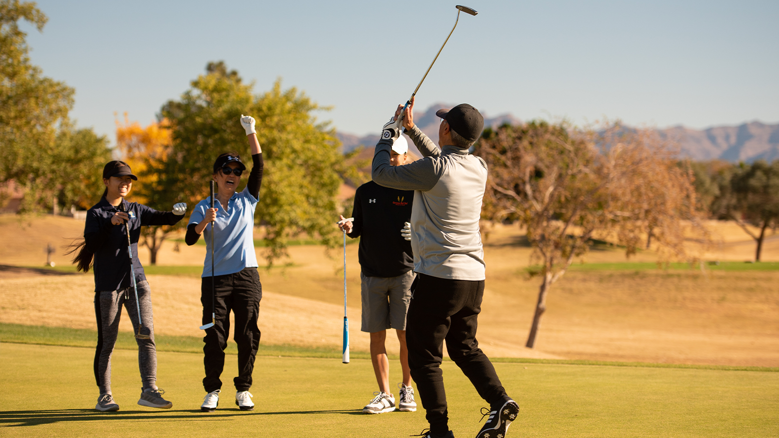 The Tokishi family celebrates Alan Tokishi's putt on the third hole during the 2020 PGA Family Cup at Augusta Ranch Golf Club on December 13, 2020 in Mesa, Arizona. (Photo by Traci Edwards/PGA of America)