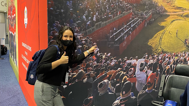 Abby Parsons pointing at herself in the Ryder Cup photo at the PGA Show.