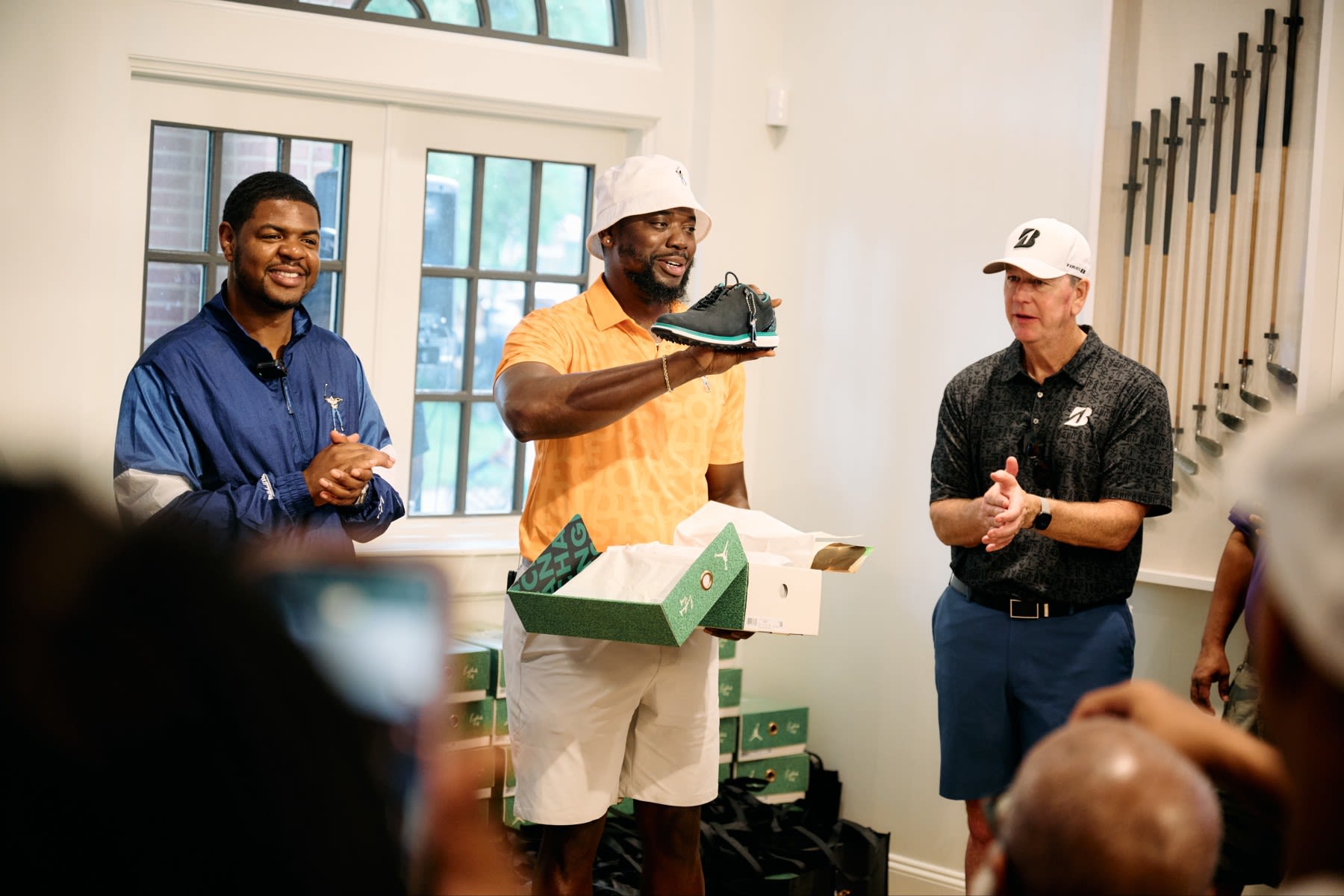 Olajuwon Ajanaku (middle) founded Eastside Golf, with PGA of America Golf Professional Earl Cooper (left).