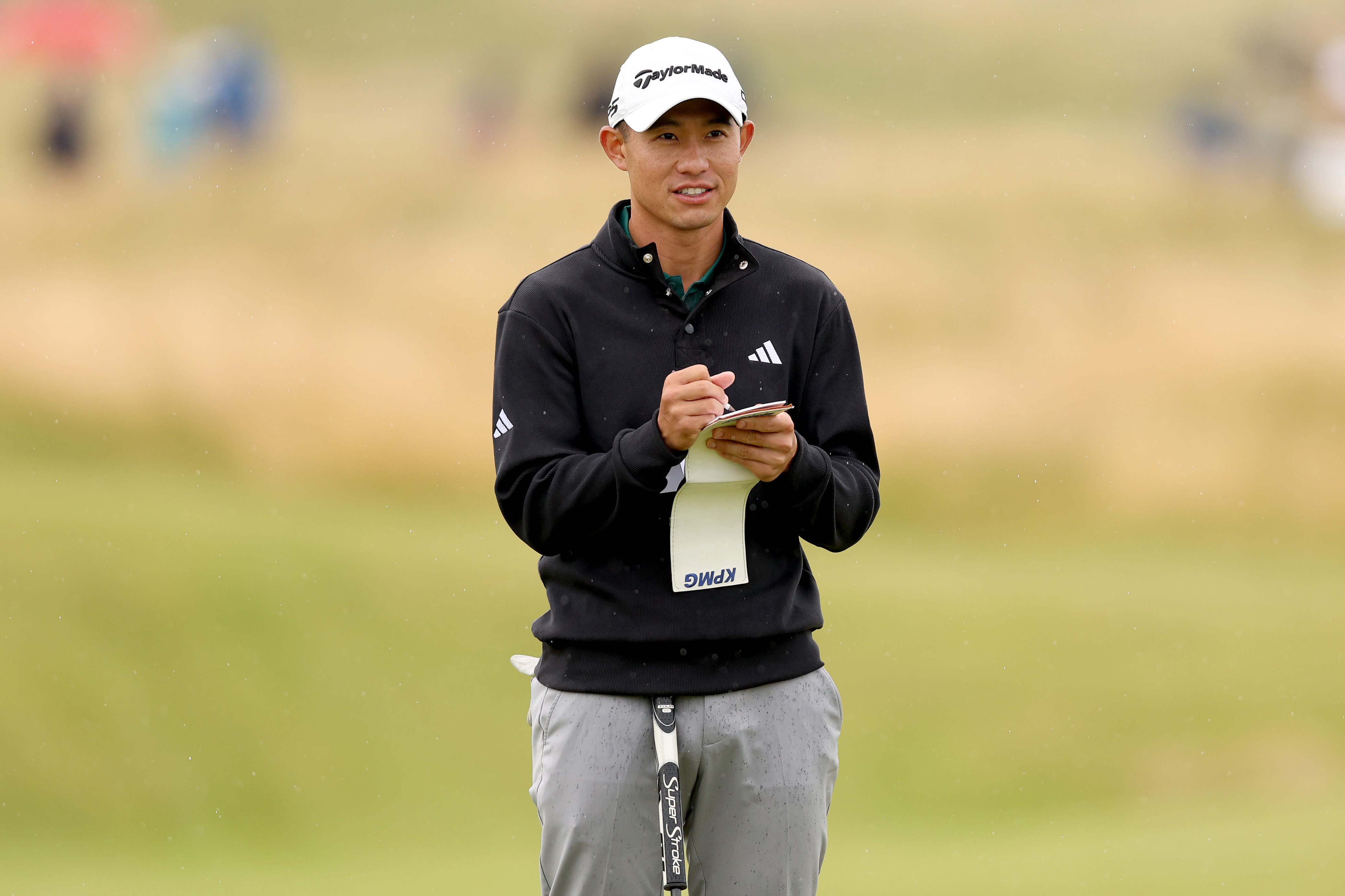 Collin Morikawa dialing in yardages during The Open Championship. (Getty Images)