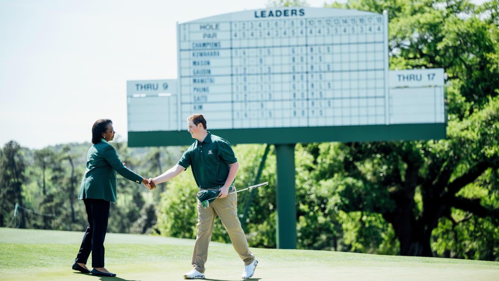 Jake Sheffield of the Boys 14-15 division is congratulated by Dr. Condoleezza Rice during the 2023 Drive, Chip and Putt National Finals at Augusta National Golf Club. (Logan Whitton/Augusta National Golf Club)
